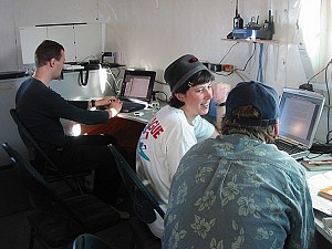 Členové posádky píší zprávy na počítačích v horním patře stanice.